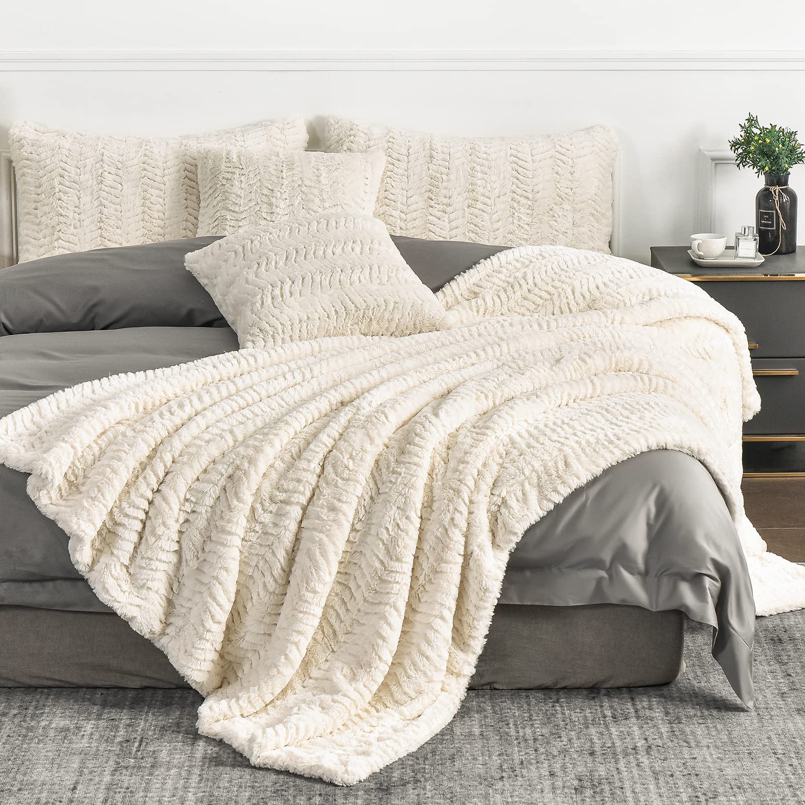 YUSOKI front view of folded ivory blanket showing plush look and inviting warmth