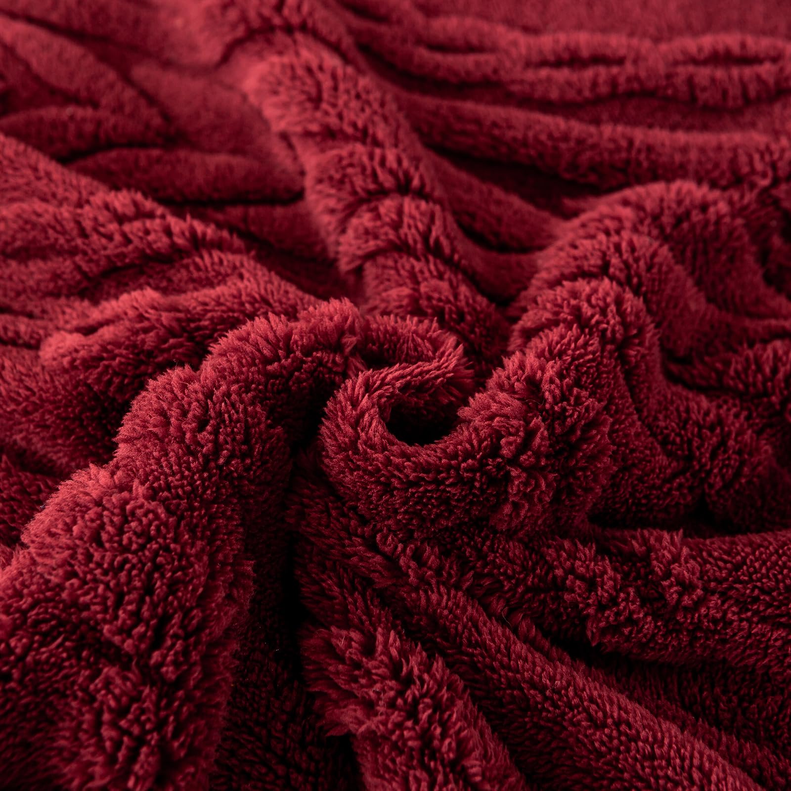 YUSOKI blanket next to chair showing 50x65 size and coverage