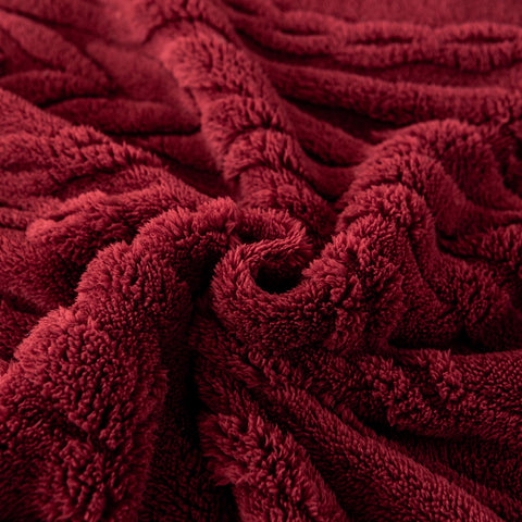 YUSOKI blanket next to chair showing 50x65 size and coverage