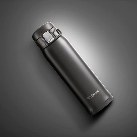 Zojirushi flip-open lid detail highlighting one-handed use and spill prevention benefit
