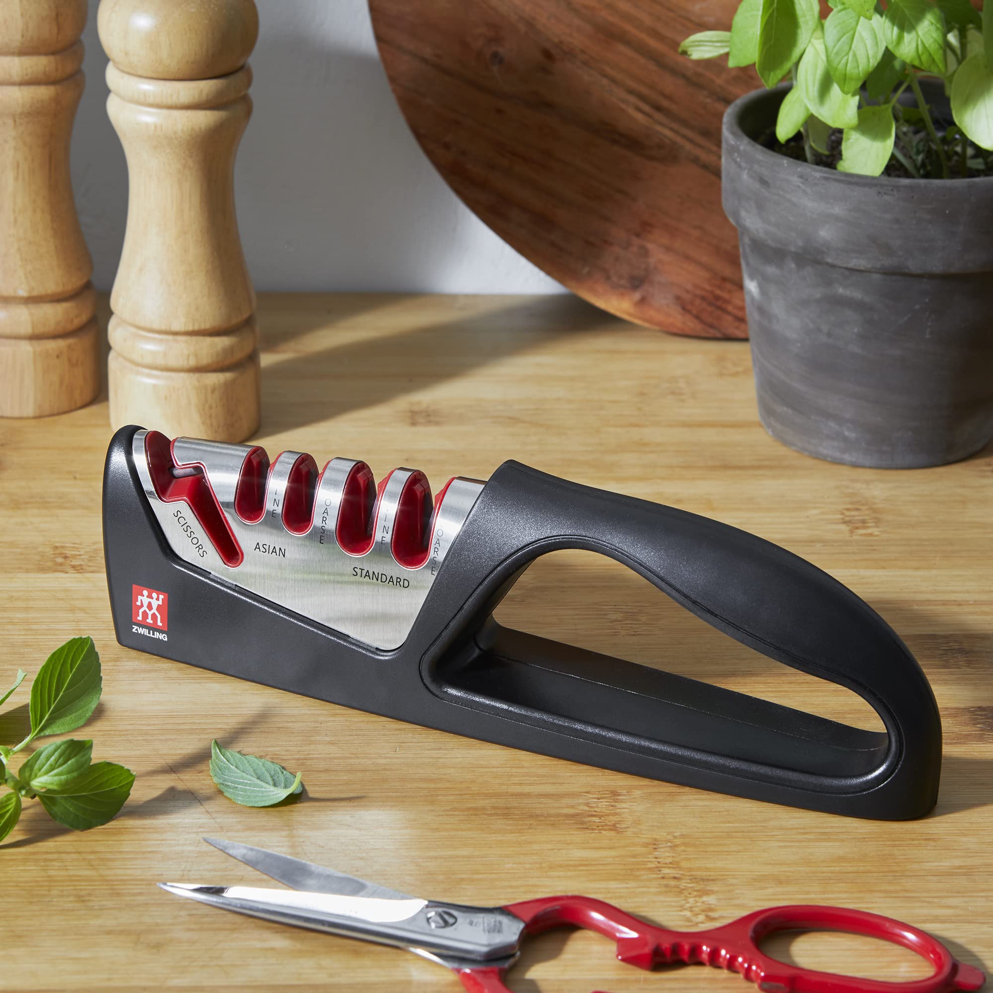 ZWILLING sharpener in use with knife in kitchen demonstrating safe grip and steady results