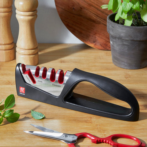 ZWILLING sharpener in use with knife in kitchen demonstrating safe grip and steady results